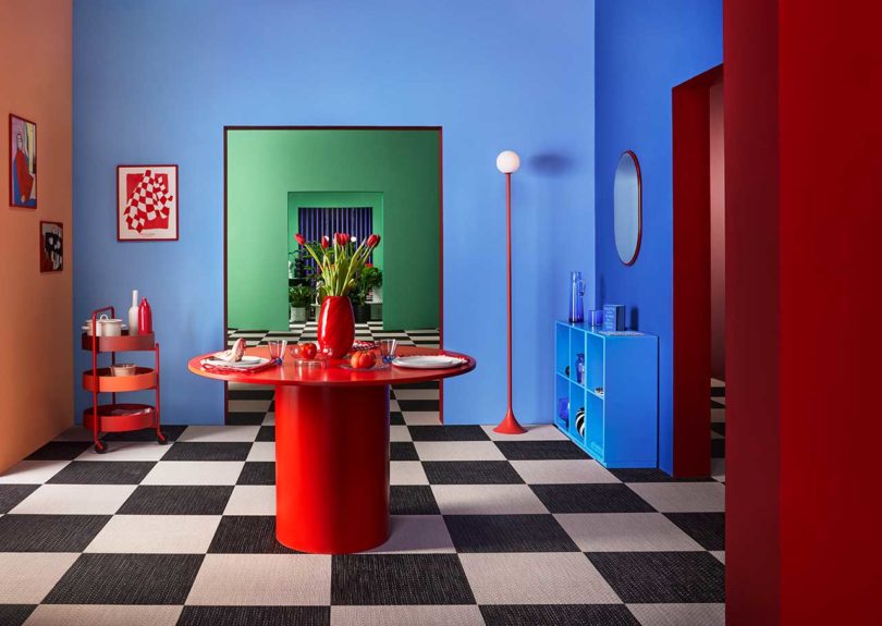 bold color-blocked dining area with red table and black and white floor