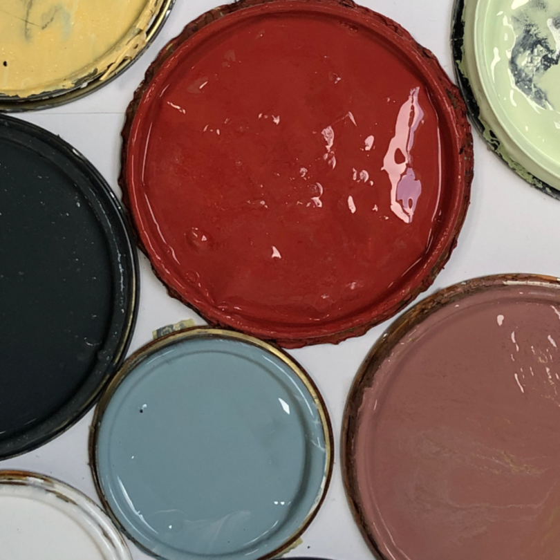 looking down at paint can lids with wet paint