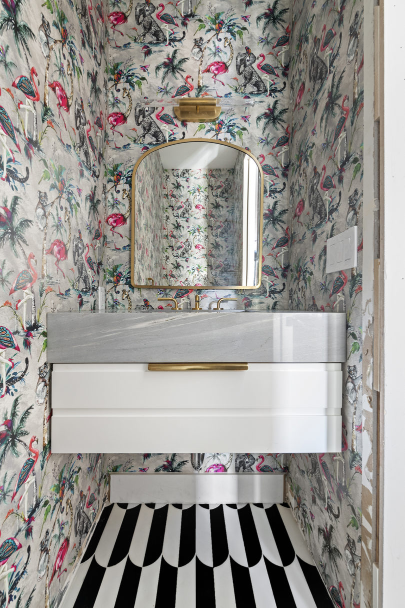 styled powder room with floating white vanity and floral wallpaper