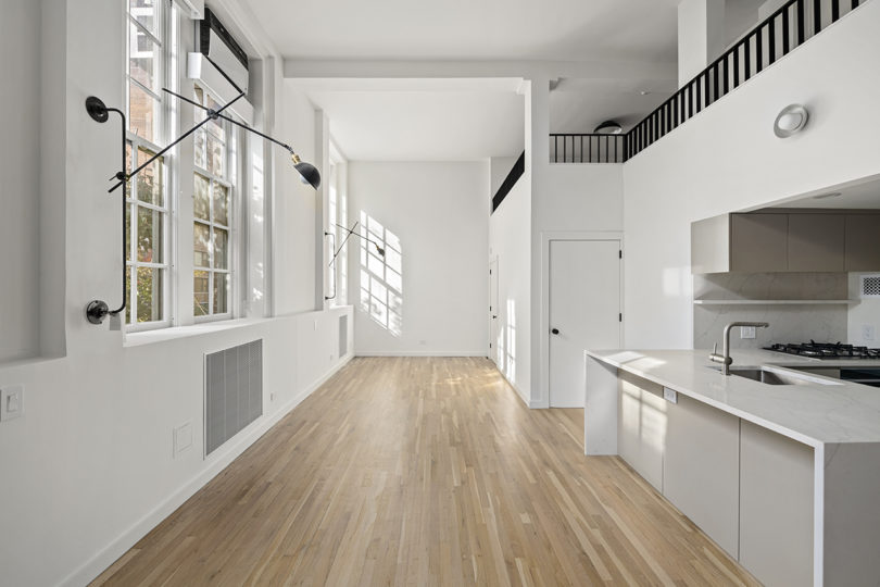 unfurnished white and natural wood loft space
