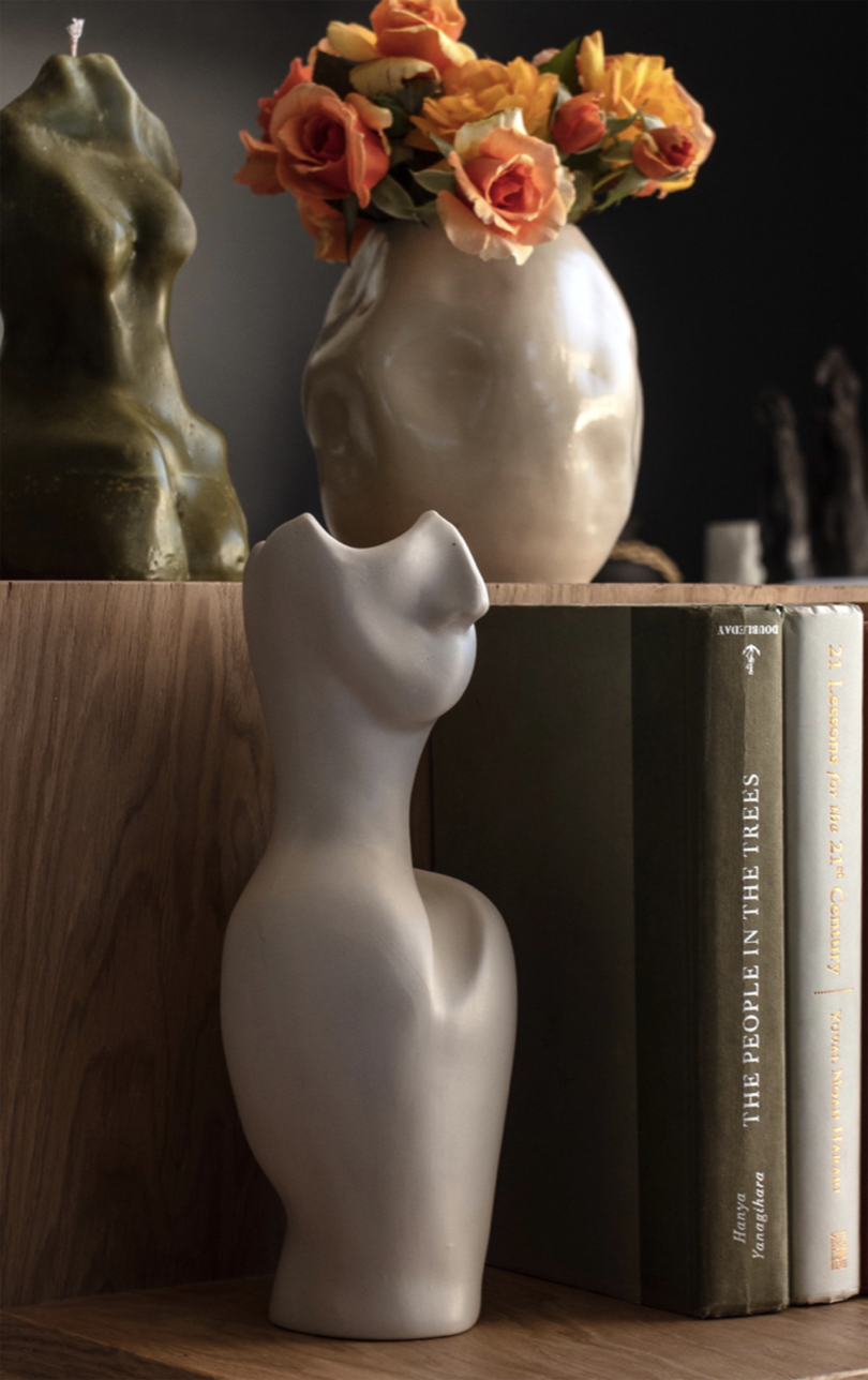 white vase in the shape of shoulders and lower face