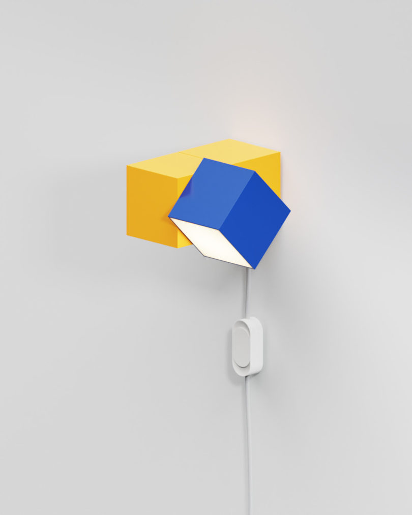 Analog wall lamp in blue and yellow colorway.