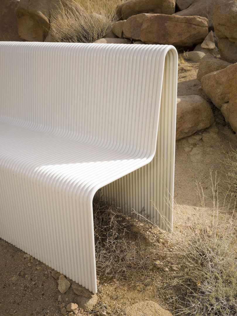detail of white metal bench in the desert