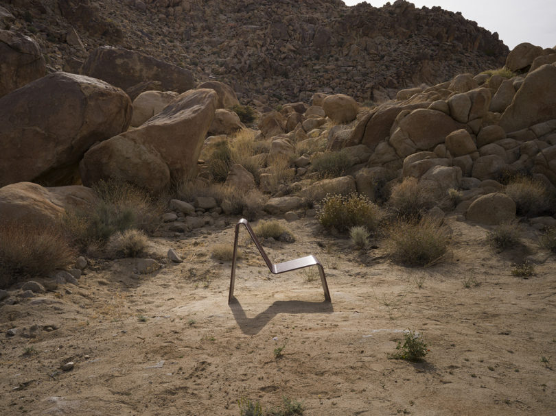 curved metal outdoor lounge chair in desert
