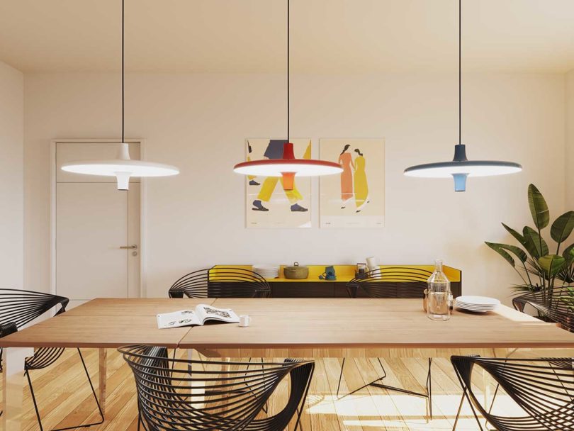 white, orange and blue pendant lamps over dining table