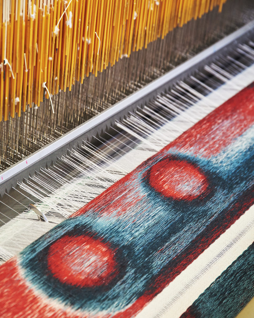 colorful tapestry being woven on a loom