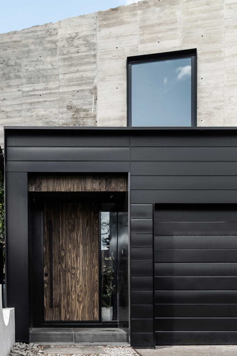 partial view of modern home exterior in concrete and black metal