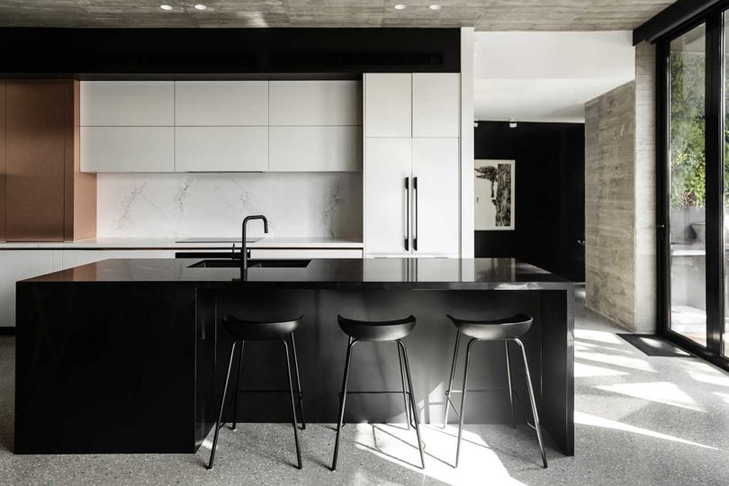 modern kitchen with white cabinets and black island