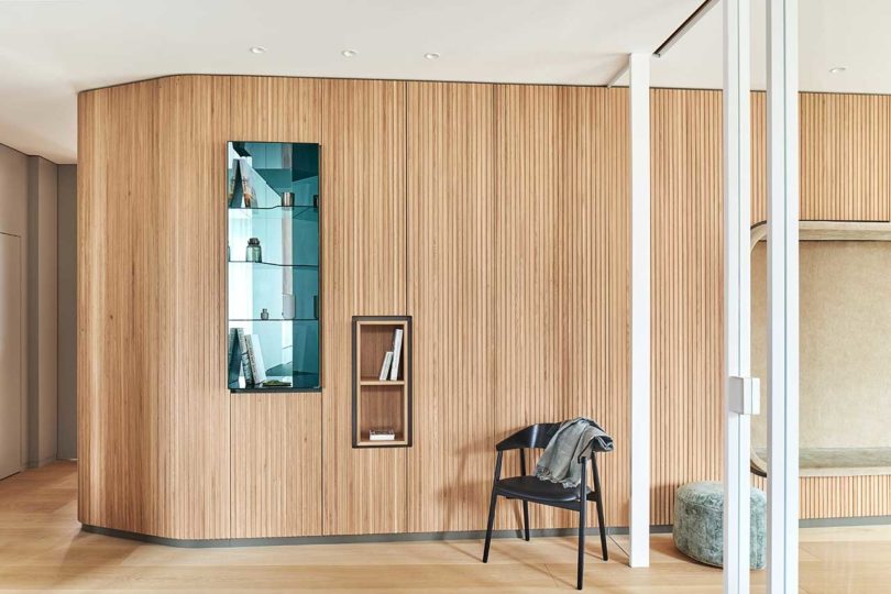 modern interior with wood slatted wall with built-in shelving