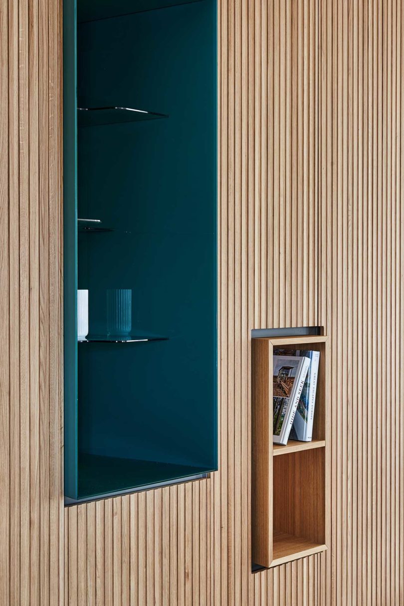closeup view of built-in cabinets with wood slat exterior and deep green inset