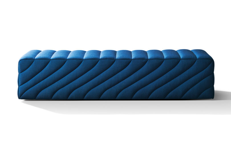 blue upholstered straight bench on white background