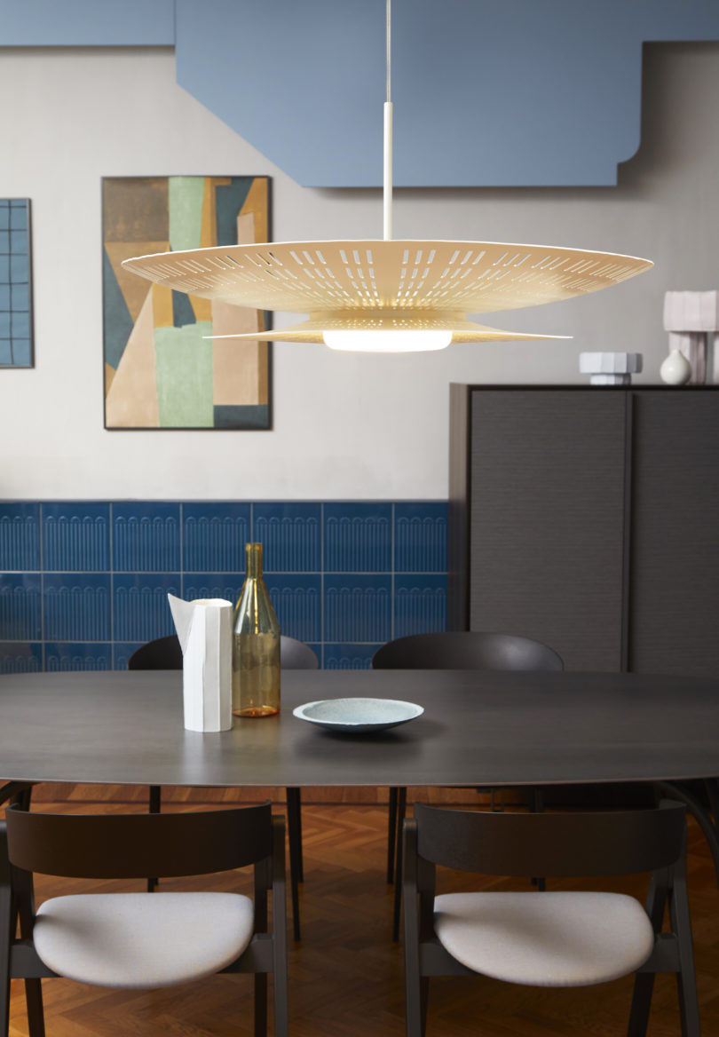 laser cut beige suspension light above dining table