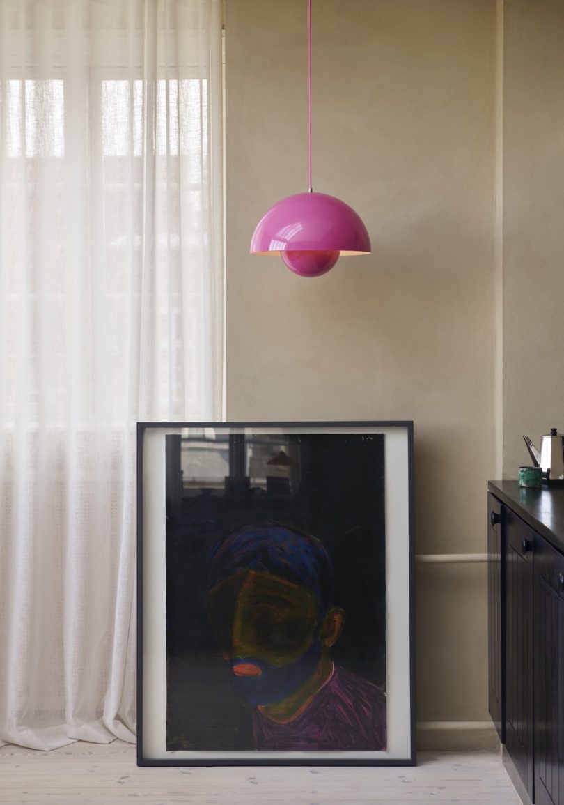 pink pendant light above artwork
