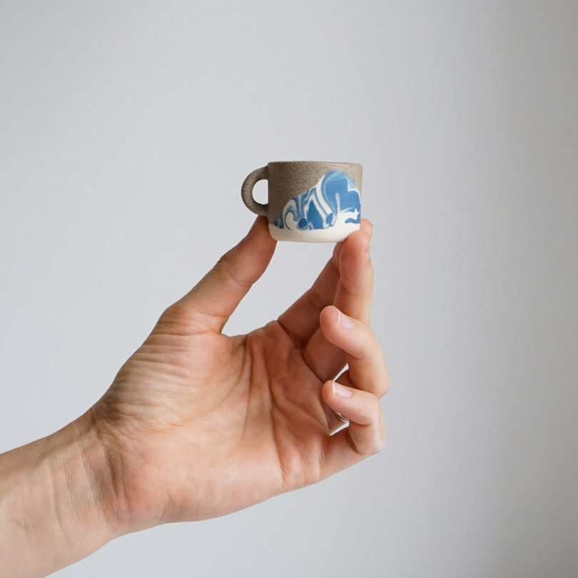 hand holding tiny mug
