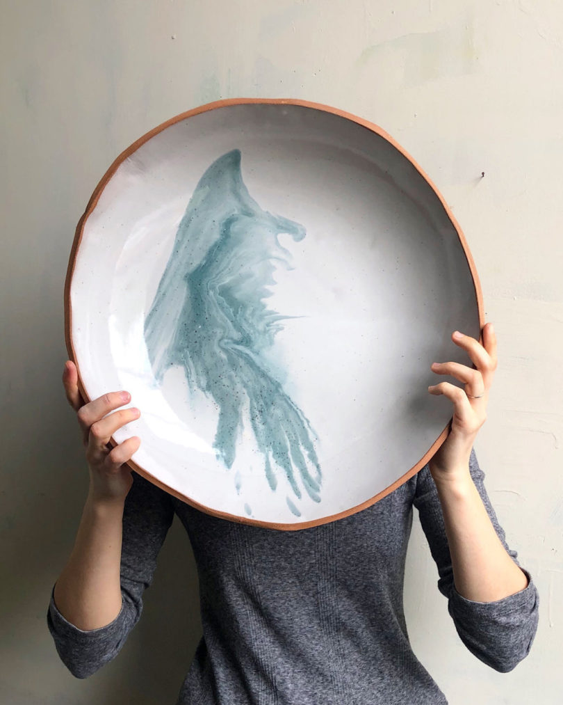 model holding giant plate