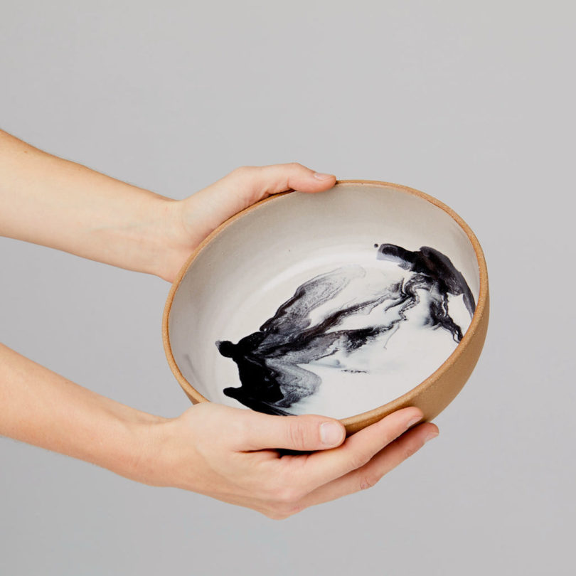 hands holding shallow ceramic bowl
