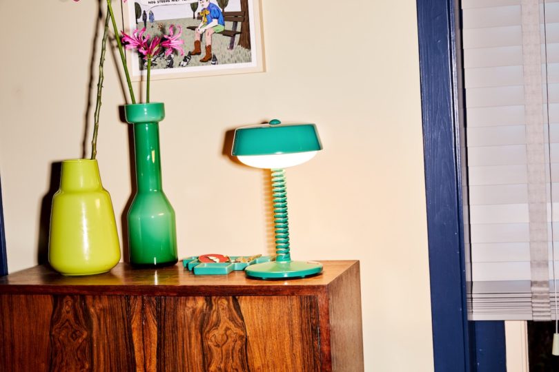 green table lamp on wood sideboard