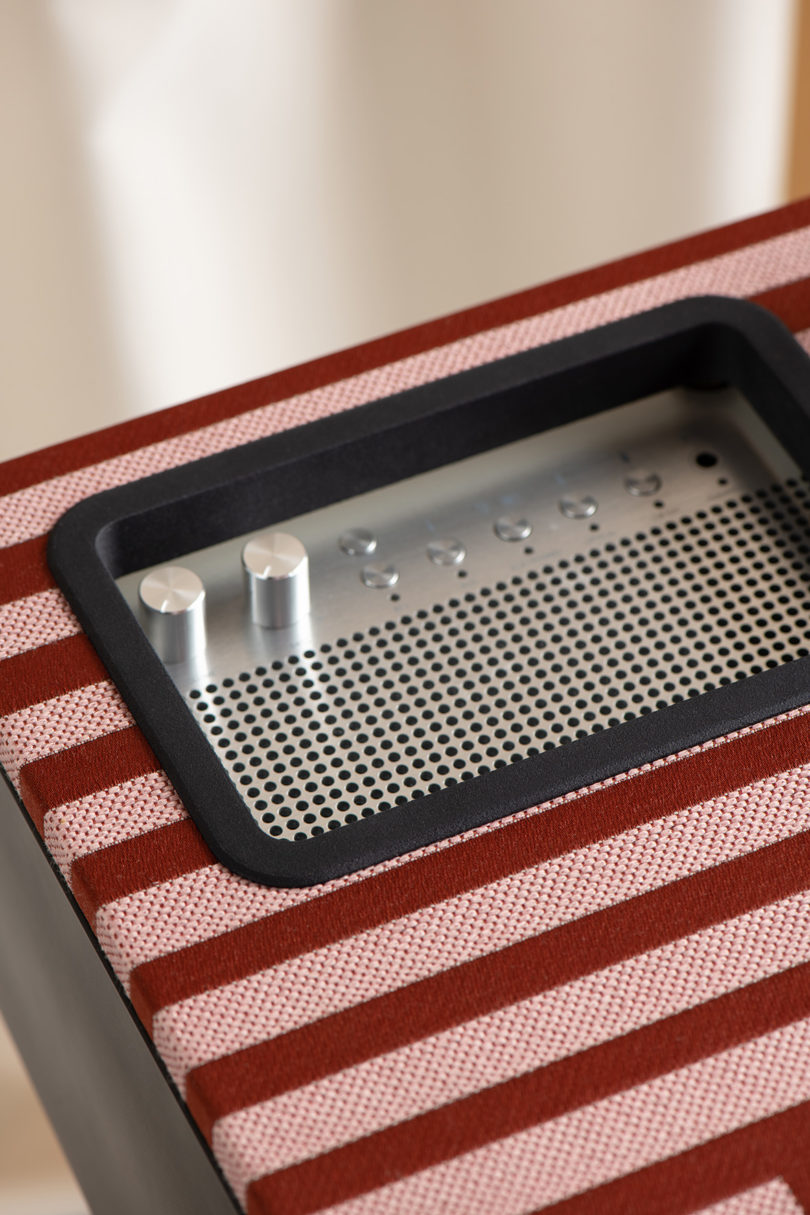 Detail of corner with red and white striped textile covering turntable top.