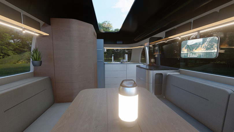 Interior view render of The Airstream Studio F. A. Porsche Concept Travel Trailer with glowing lantern.
