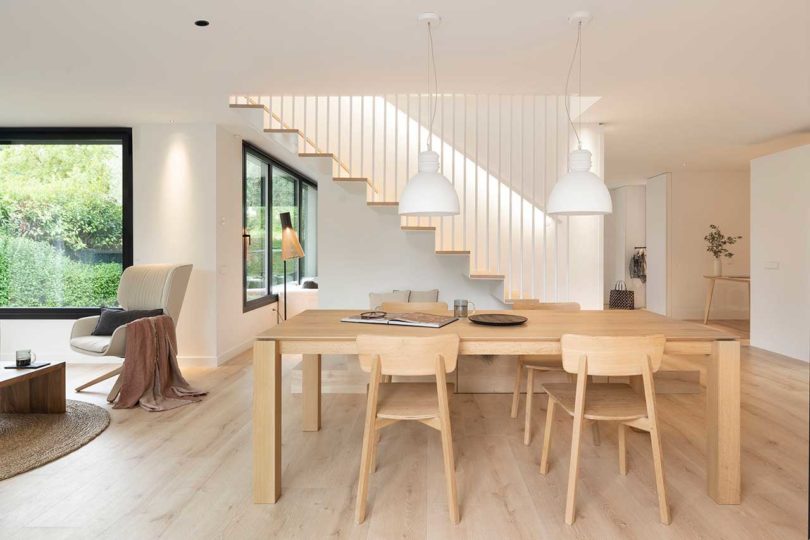 interior shot of modern home's dining room with light wood table