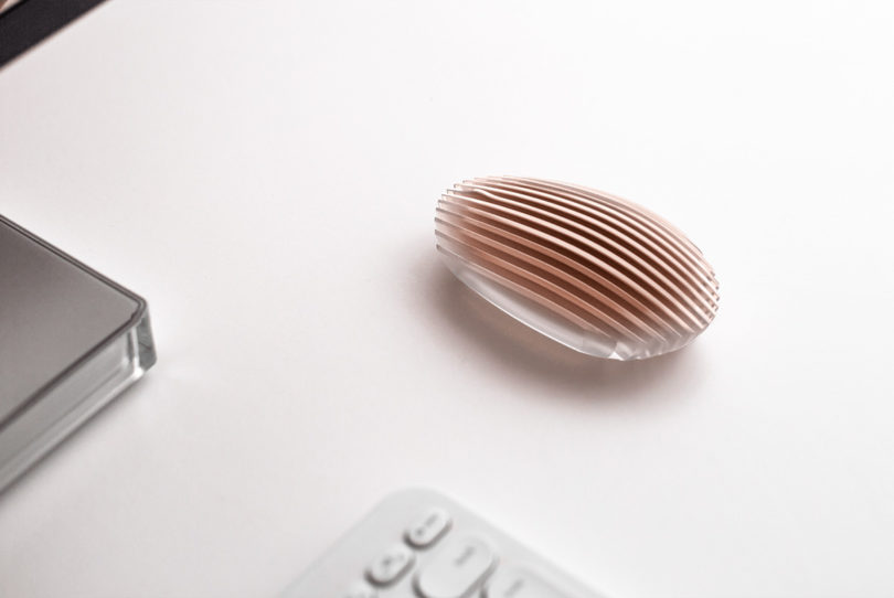 Transparent vent design Dune Mouse in copper tint set against white background, near keyboard.