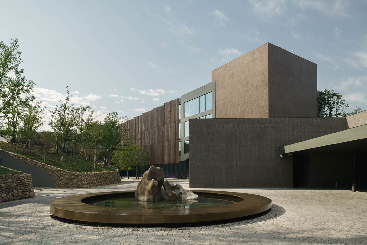exterior of modern building with round fountain