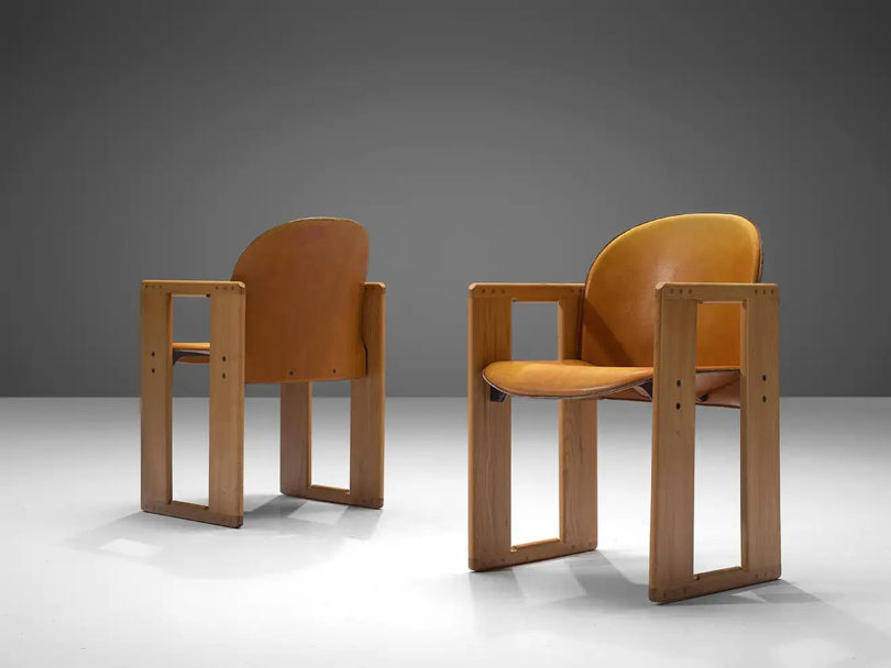 two wood dining chairs with arms