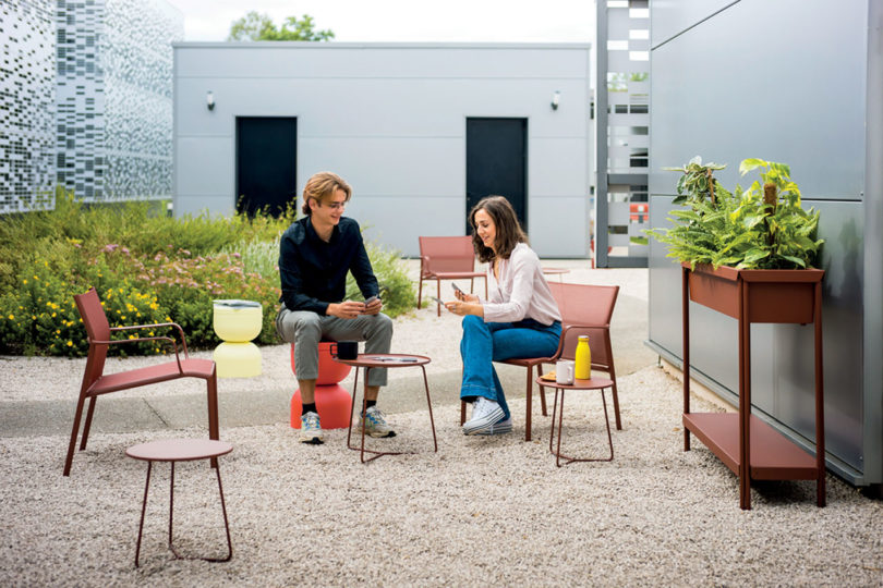 colorful outdoor seating with two people sitting and conversing