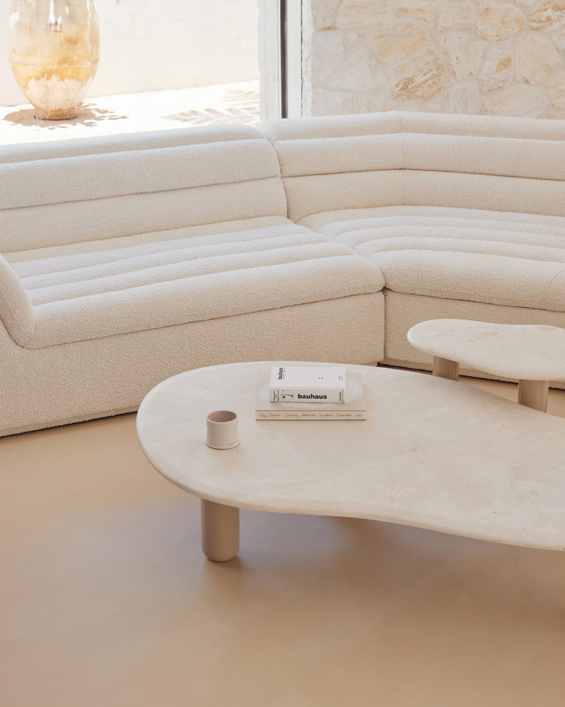 white sectional sofa with two coffee tables