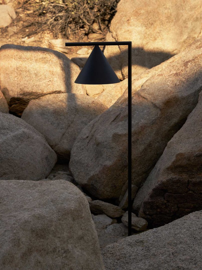modern black outdoor light fixture amongst rocks