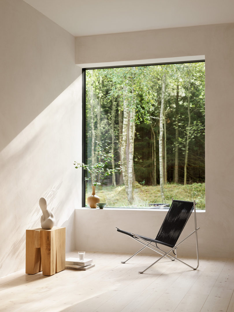 modern chair with rope back and seat and wood occasional table in a styled interior space