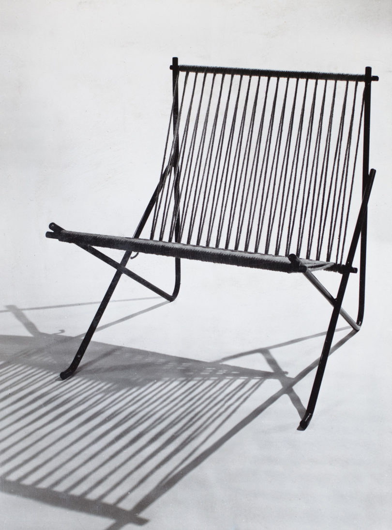 black and white archival image of a chair with rope back