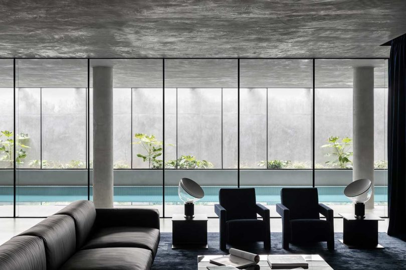 modern living room interior looking out to indoor swimming pool