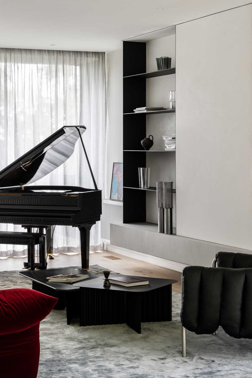 modern living room interior with black piano and minimalist bookshelves