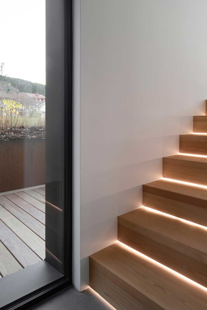 angled view of simple modern wood stairs with lights