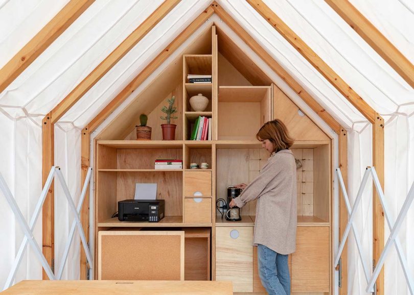 view inside expandable living shelter with woman standing