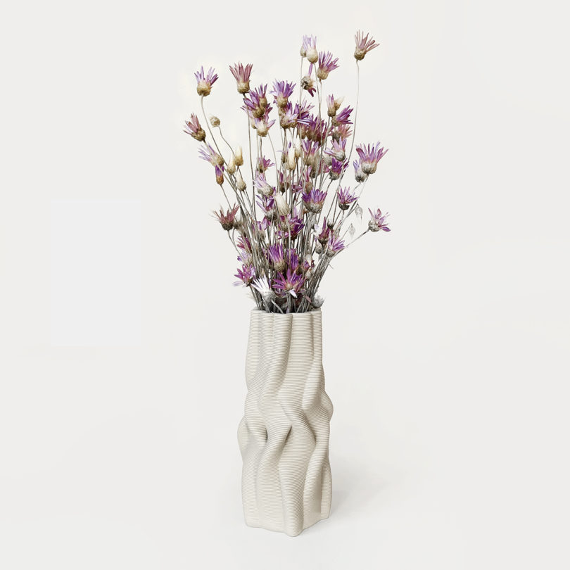 white 3D printed vase with flowers on a white background