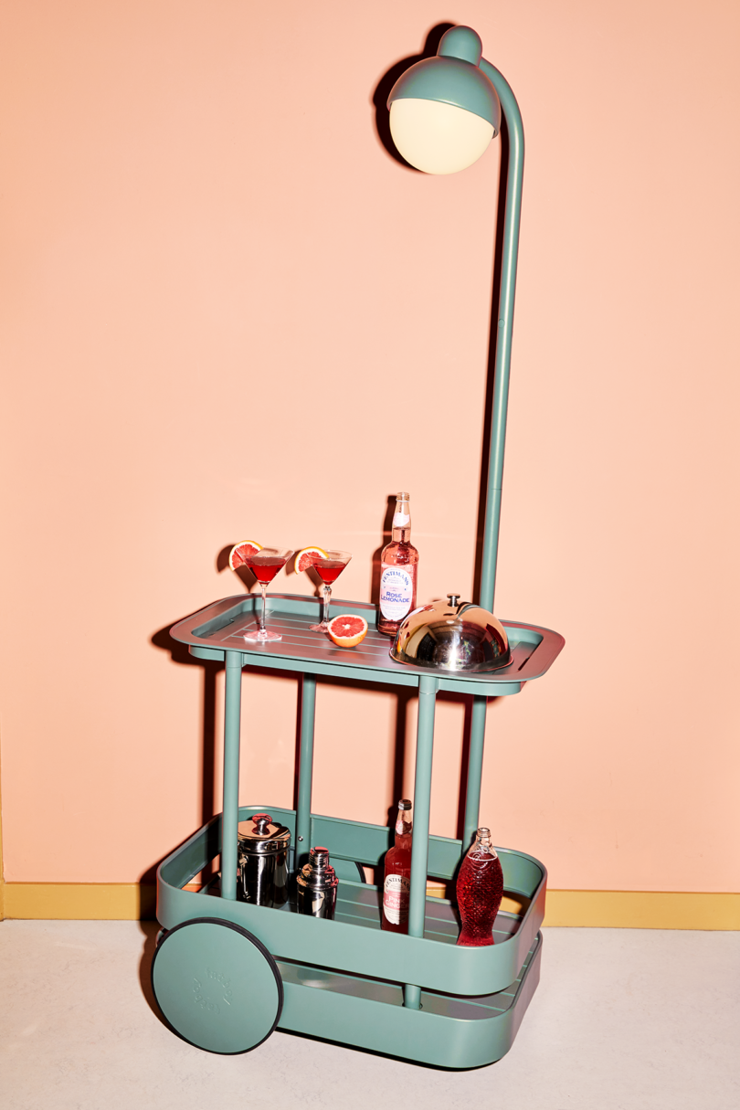 styled teal bar cart with light