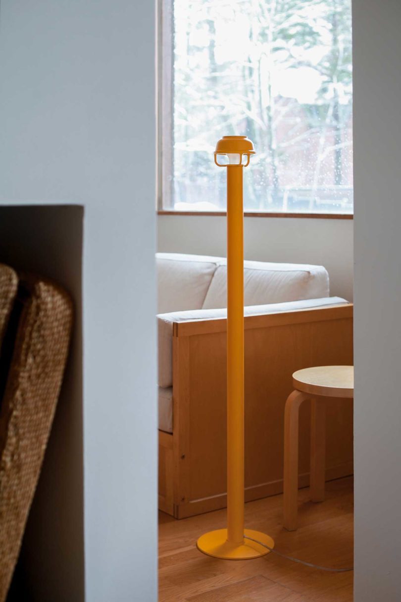 matte yellow modern floor lamp in styled living space