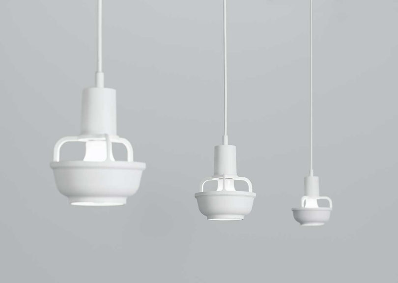 three modern suspended matte white lights
