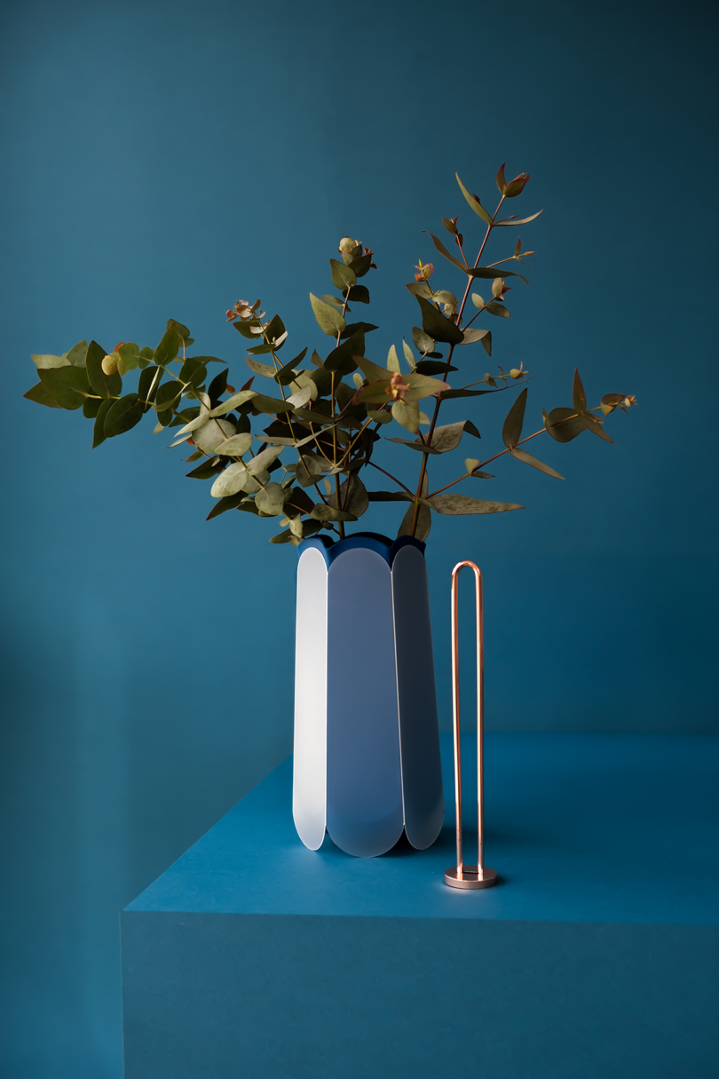 blue hexagonal-shaped vase with flowers