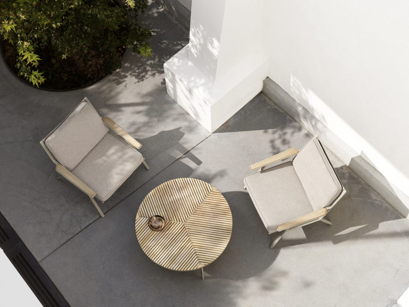 two outdoor lounge chairs and a coffee table styled