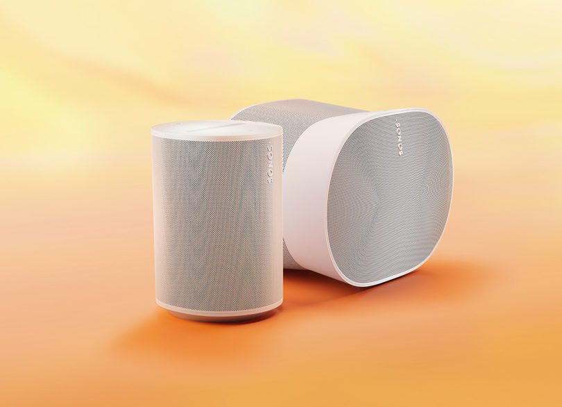 White Sonos Era 100 and 300 shown side by side against an orange to light yellow gradient background.