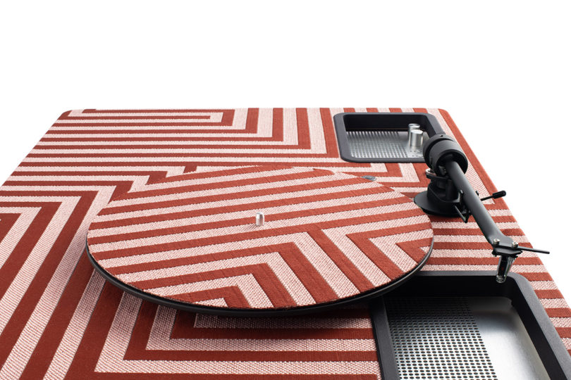 Overhead view of red and white striped textile covering turntable top.
