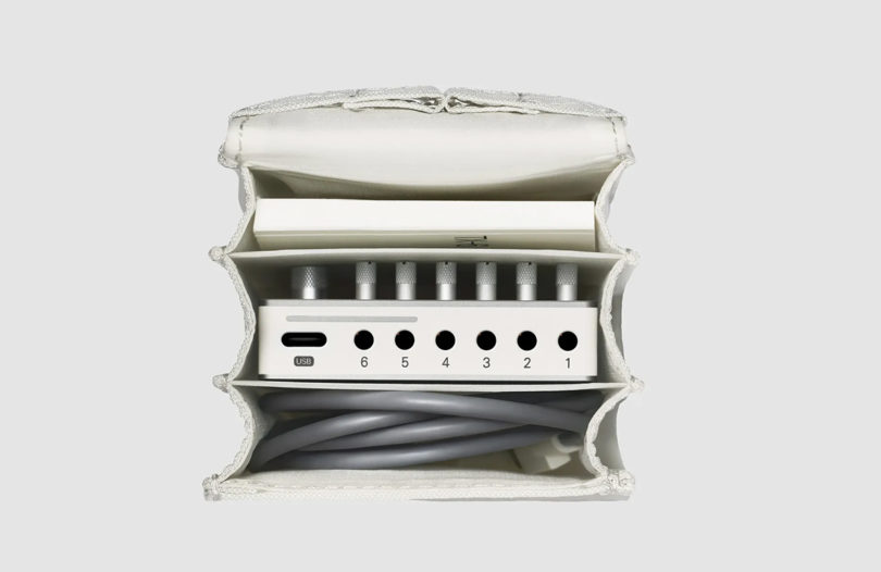 Product shot of Teenage Engineering all-white Field Series field accordion bag shown open from overhead to display carrying capacity within.