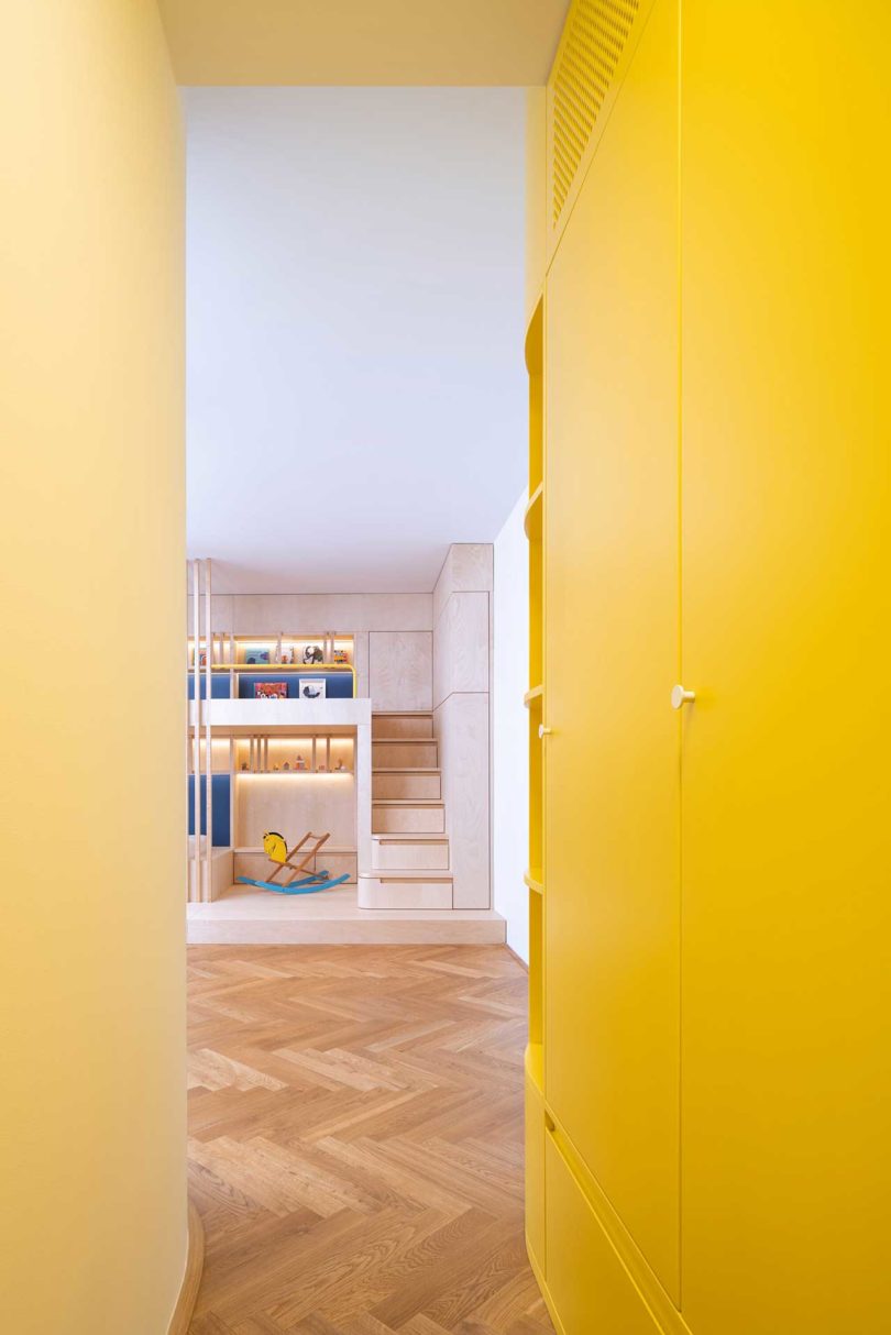view from yellow hallway into room with built-in bunk beds