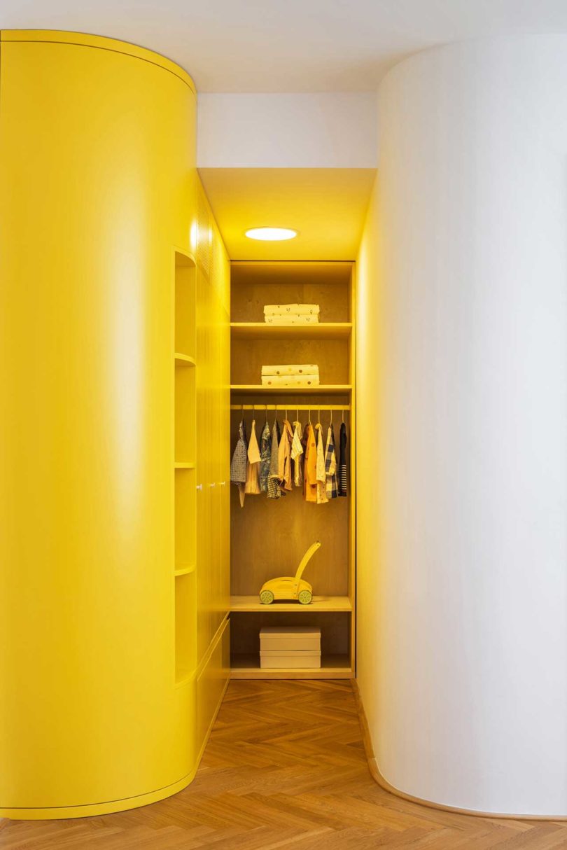 yellow and white hallway with closet storage