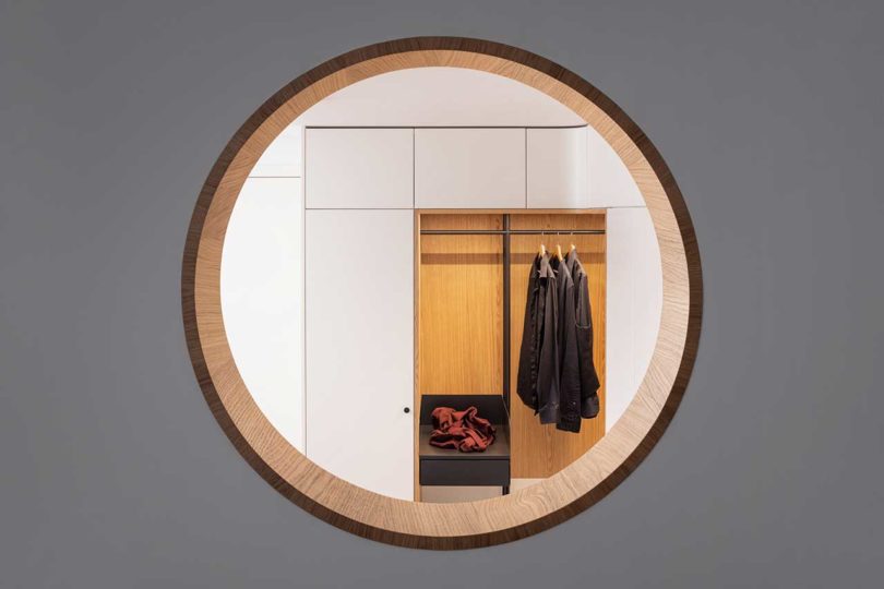 looking through circular cutout into modern closet
