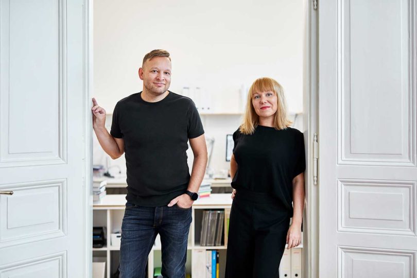 man and woman in black standing in doorway