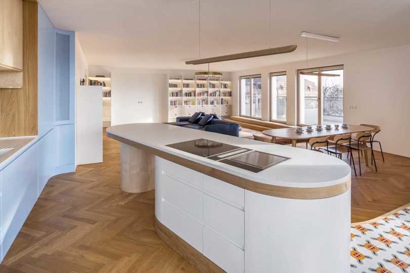 angled interior view of modern kitchen with oval island